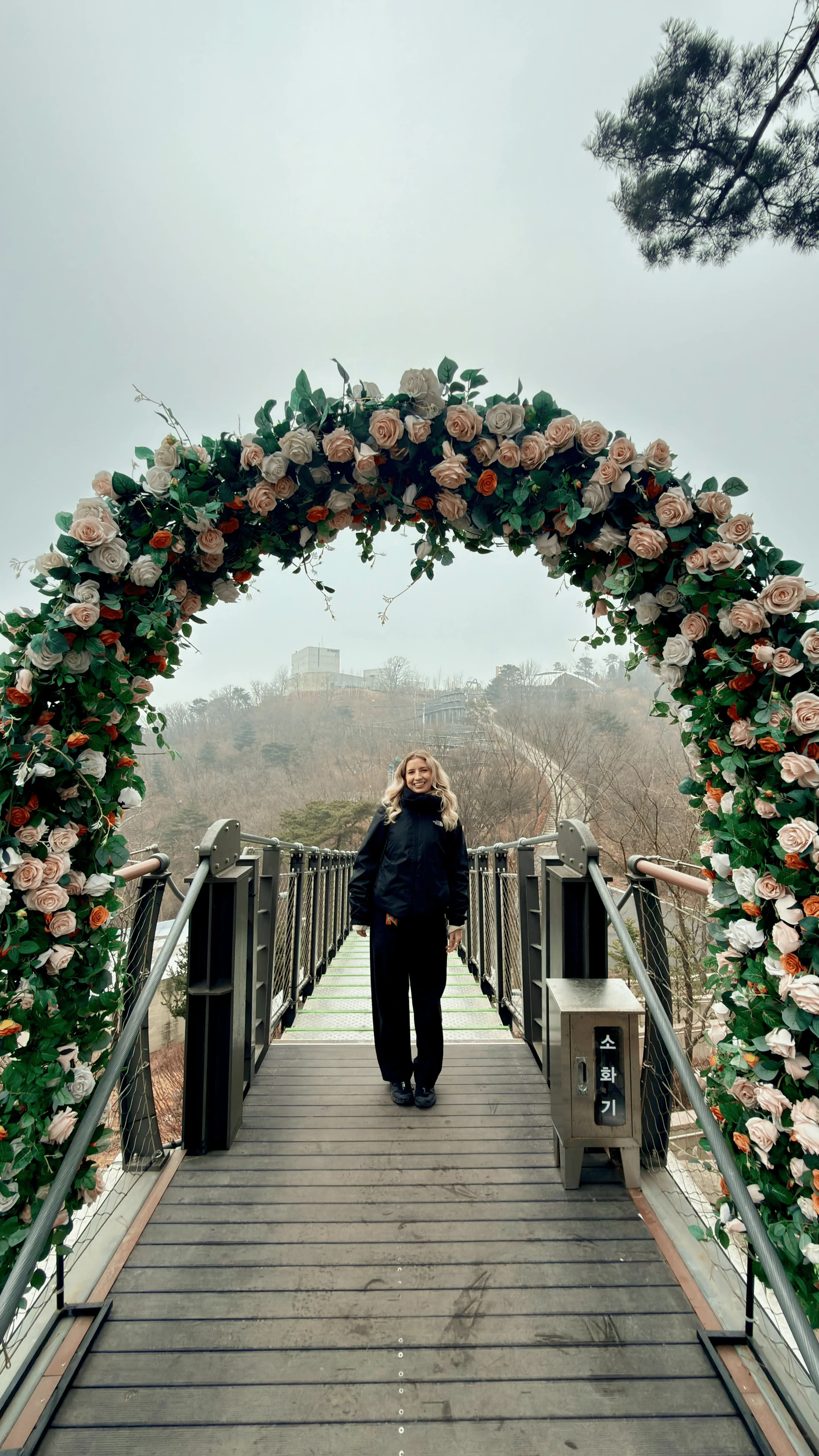 Tiah standing under a flower arch